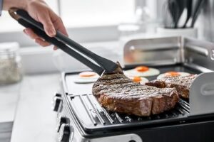 Elevate your grilling game with the GreenPan Stainless Steel Elite XL Smoke-less Grill & Griddle, featuring healthy ceramic nonstick surfaces and interchangeable cast aluminum plates.