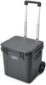 Stay cool on the go with the Roadie 48 Wheeled Cooler featuring a retractable periscope handle and large storage capacity, perfect for camping trips or tailgating events.