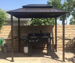 Here is the generated SEO meta description:

"Stay shaded and grill on with this permanent metal roof gazebo featuring 2 side shelves for patio gatherings. Perfect for outdoor BBQs and yard events, its aluminum frame provides durable protection."