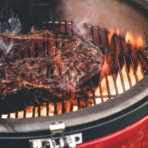 Master the art of slow cooking with Kamado Joe's Classic Joe Series II ceramic grill and smoker. Enjoy 250 sq inches of cooking space, AirLift Hinge, and Kontrol Tower Top Vent in a durable red design, perfect for backyard BBQs.
