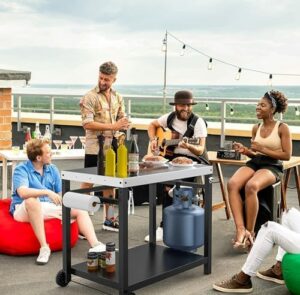 Here is the meta description:

"Transform your outdoor cooking experience with this LS'BABQ grill table featuring a pizza oven stand, prep area, and stainless steel flattop. Ideal for entertaining, perfect for wheels and hooks."