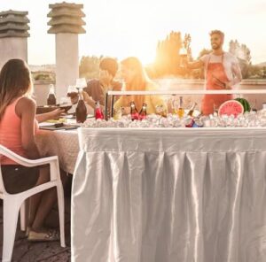"Perfectly portable party solution: drain-enabled bar table with skirt and upper bracket, ideal for outdoor events. Dimensions 35x23x27 inches."