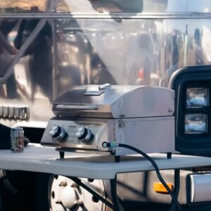"Upgrade your outdoor cooking experience with Monument Grills' portable propane gas grill. Features stainless steel lid, built-in thermometer, and travel locks for easy transport."
