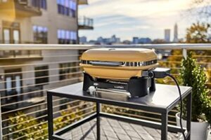 Discover the Weber Lumin Compact Outdoor Electric Barbecue Grill, perfect for small spaces like patios, balconies, and decks. Portable and convenient, this yellow grill is ideal for outdoor cooking.