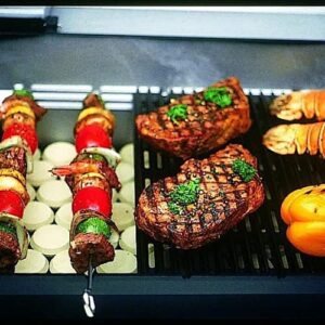 "Upgrade your outdoor cooking experience with MHP WHRG4DD Hybrid Propane Gas Grill, featuring SearMagic grids on a stainless steel cart. Perfect for BBQ enthusiasts and family gatherings."