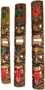Discover vibrant tropical artistry with Zeckos' Set of 5 Hand-Carved Double Tiki Mask Totem Wall Sculptures, crafted from sustainable wood and standing 40 inches tall. Perfect for indoors and outdoors decor.