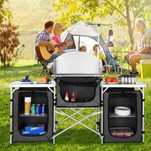 Discover a portable camping kitchen table for outdoor adventures! Aluminum folding design with windshield and 3 cupboard storage. Perfect for picnics, beach parties, or cooking on-the-go.