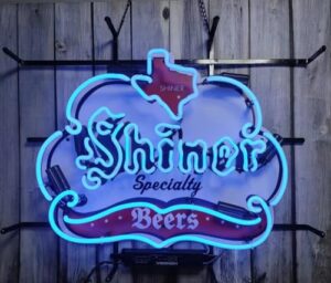 Here is the generated meta description:

"Add a touch of style to your man cave or pub with this handmade neon sign featuring Shiner Beer's iconic logo, crafted with real glass tube lighting and durable inch tubing."