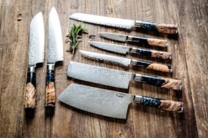 Elevate your culinary experience with the Epicurean Cook Tidal Collection 8 PCS Damascus Knife Set, featuring VG10 steel core ultra-sharp blades and elegant black resin and burl wood handles. Perfect for professional chefs!