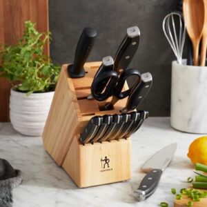 Elevate your cooking experience with the Henckels Forged Premio 13-Pc Knife Set. Includes chef, paring, utility, and steak knives plus a storage block, all crafted in stainless steel and featuring a light brown finish.