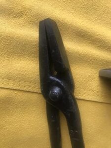 Discover the ultimate blacksmithing starter kit from Hammer & Tongs. Includes hammer, tongs, leather apron, safety glasses, beeswax, and steel brush. Perfect for beginners and professionals alike!