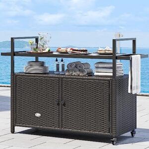 "Transform your outdoor gatherings with the Large Outdoor Kitchen Wicker Island Rolling Cart & Patio Bar Table, featuring a black glass table top, dark brown wicker design, and convenient wheels. Perfect for backyard and poolside entertaining."