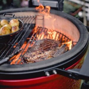 Cook up a backyard culinary masterpiece with the Kamado Joe Classic Joe Series II Ceramic Charcoal Grill and Smoker. Features 250 sq inches of cooking space, stainless steel grates, and side shelves for easy prep.