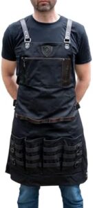 Professional-grade kitchen apron by Dalstrong for chefs and cooks. Durable, stain-resistant, and adjustable neck strap design. Perfect for messy cooking tasks, with 100% polyester fabric and reinforced seams.
